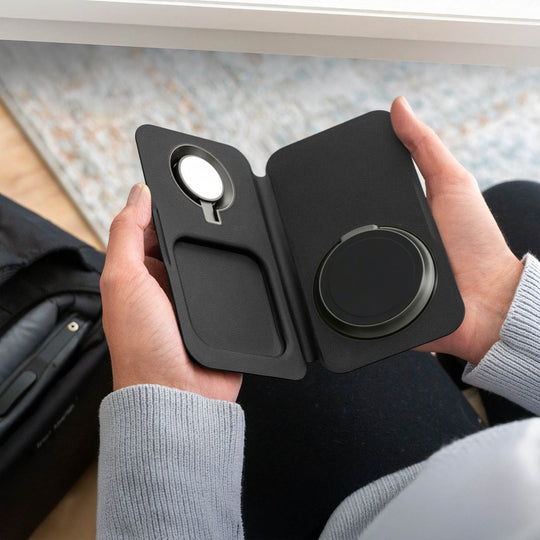 Person holding a black FOLD 3-in-one-Wireless Charger
