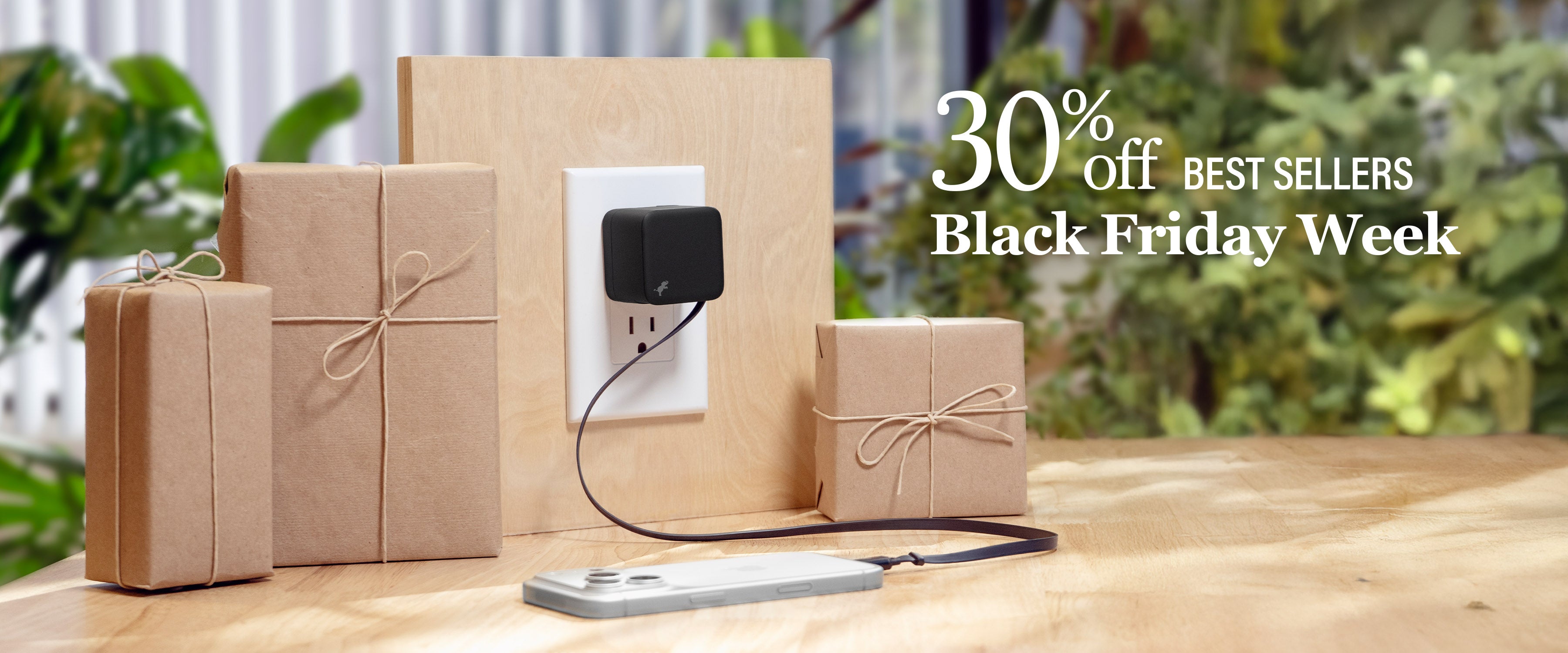 Gift boxes with a power adapter on a wooden surface, promotional text 30% off BEST SELLERS Black Friday Week