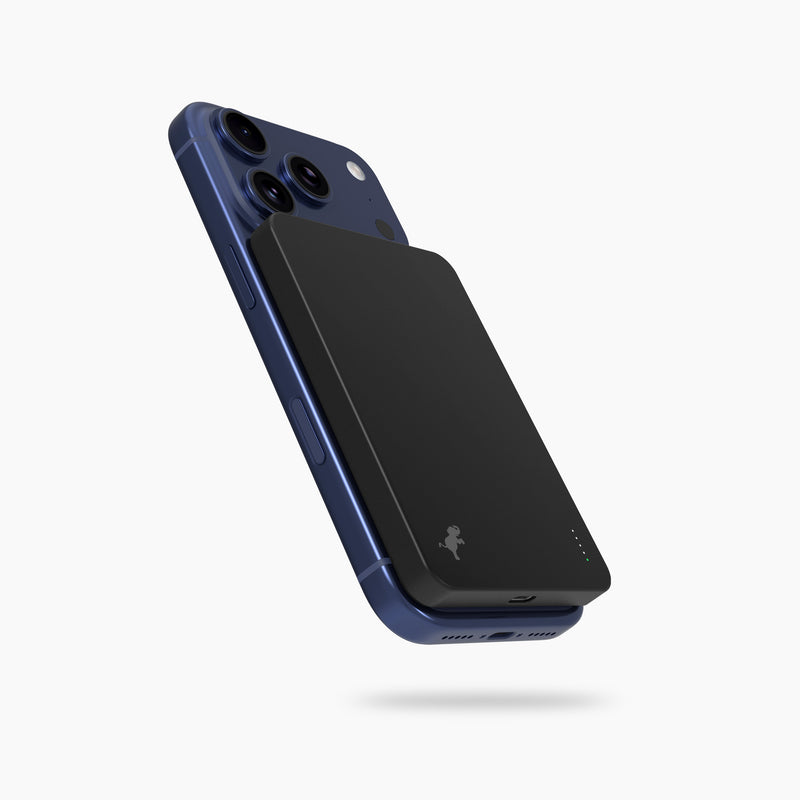 Blue iphone with a black nimble magnetic phone charger on the back, magsafe phone charger magnetic battery pack.