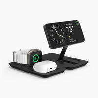 A black Fold 3-in-1 wireless charger with dedicated charging zones for an iPhone, Apple Watch, and AirPods, displayed in a stand-by mode.