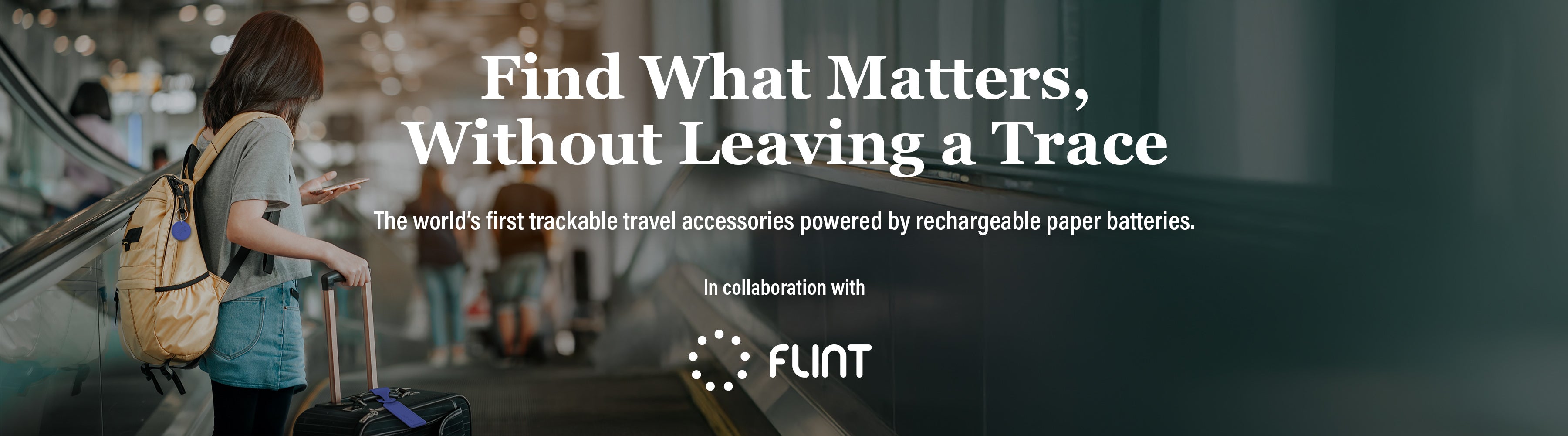 Person with a backpack and suitcase in an airport setting, with text about trackable travel accessories and rechargeable paper batteries in collaboration with the brand FLINT.