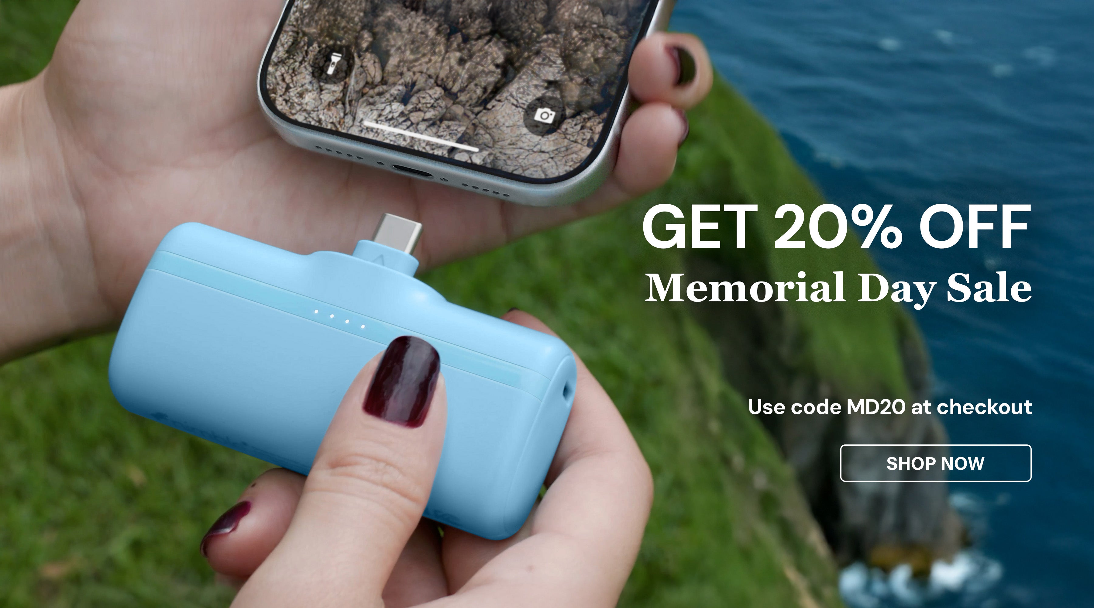 Person holding a phone with a blue Bump portable charger near water, promotional text overlay for Memorial Day sale.