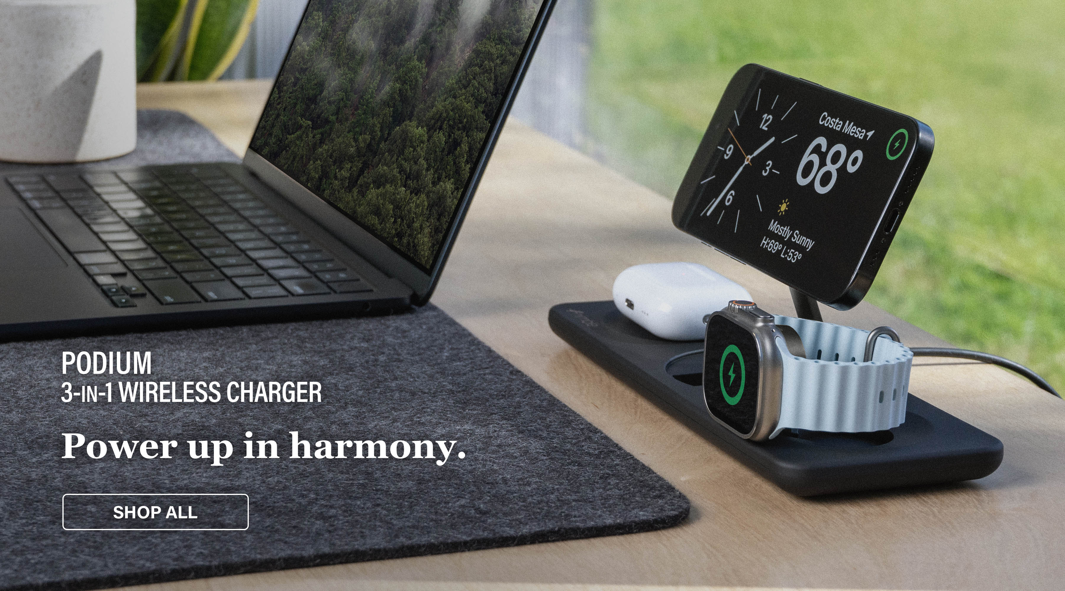3-in-1 wireless charger with iPhone, Apple Watch, and AirPods on a desk and text Power up in harmony. PODIUM 3-in-1 Wireless Charger.