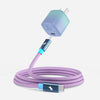 A USB-C charging cable with a lavender purple braided cord, a blue and white gradient wall charger, and metallic blue USB-C connectors, shown on a light gray background.